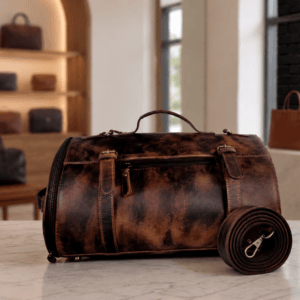 DayLife Leather Handcrafted Distressed Brown Leather Duffle Bag | Vintage Travel Weekend Bag DayLife Leather handcrafted distressed brown leather duffle bag with a matching shoulder strap on a marble surface, available at daylifeleather.com.
