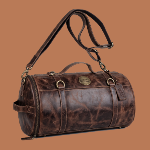 DayLife Leather vintage brown distressed leather duffle bag with shoulder strap on a rustic wooden table