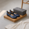 DayLife Leather Premium Blue Tabi Mary Jane Flat Shoes for Women A pair of premium DayLife Leather navy blue tabi-toe Mary Jane flat shoes with black elastic straps, displayed on a wooden block next to a branded grey shoe box at DayLifeLeather.com.