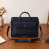 Premium genuine leather bag for business professionals. A luxury blue leather office bag with dual handles and gold DayLife Leather signature details.