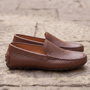 premium-brown-leather-loafers-men.jpg Close-up shot of a man wearing premium brown textured leather loafers, comfortable slip-on leather shoes for men.