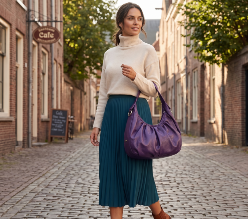 Side profile of Daylife Leather vibrant purple ruched slouchy hobo bag standing on a rustic wooden table.