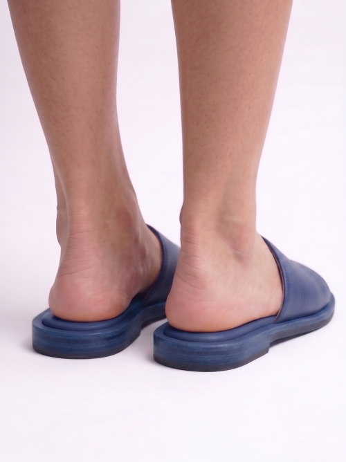 Top view of a pair of men's blue textured leather slippers, comfortable flat slide chappal for daily wear.