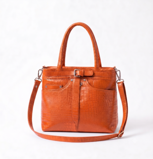 Professional woman wearing a beige blazer styling a DayLife Leather orange croco-textured office bag for women.