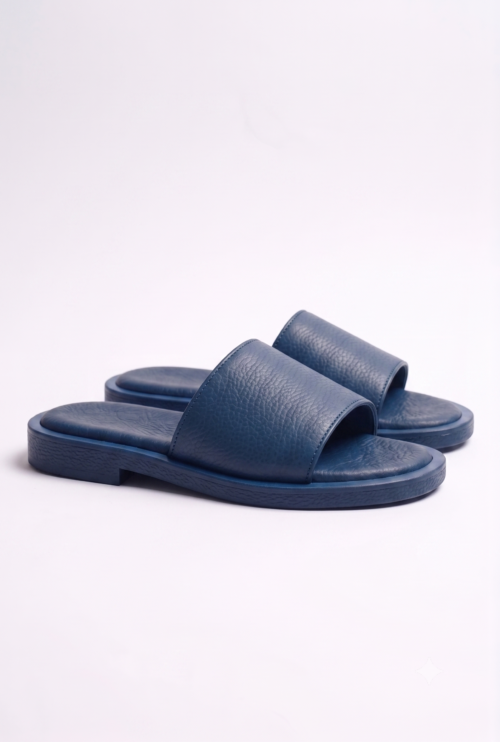 Top view of a pair of men's blue textured leather slippers, comfortable flat slide chappal for daily wear.