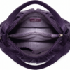 Side profile of Daylife Leather vibrant purple ruched slouchy hobo bag standing on a rustic wooden table.