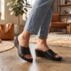 DayLife Leather women's black leather wedge sandals showcased in a well-lit studio home interior.