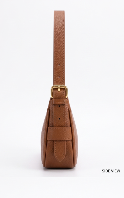 Side profile of DayLife Leather tan brown leather bag highlighting the slim profile, pebbled texture, and strap adjustment buckle.