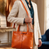 DayLife Leather premium orange textured genuine leather bag with dual top handles and a detachable shoulder strap.