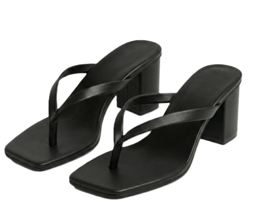A pair of DayLife Leather black square-toe heeled sandals with thong-style straps, displayed on a rustic stone tiled floor surrounded by terracotta planters at DayLifeLeather.com.