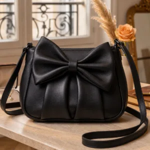 DayLife-Leather-Luxury-Black-Genuine-Leather-Bow-Knot-Shoulder-Bag DayLife Leather Luxury Black Genuine Leather Bow-Knot Shoulder Bag with adjustable strap placed on a table.