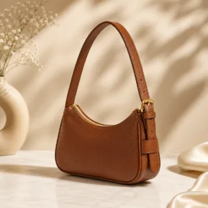 daylife-tan-brown-genuine-leather-shoulder-bag-multi-view.jpg Perspective view of DayLife Leather tan brown pebbled leather shoulder bag with adjustable strap, gold buckle, and zipper closure.