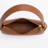 Open interior view of DayLife Leather genuine leather shoulder bag showing smooth lining and gold zipper puller details.