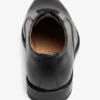 Top-down view of a single polished black leather Oxford shoe isolated on a white background.