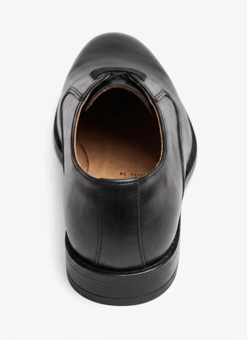 Top-down view of a single polished black leather Oxford shoe isolated on a white background.