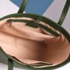 Inside view of green leather tote bag showing zip pocket and lining