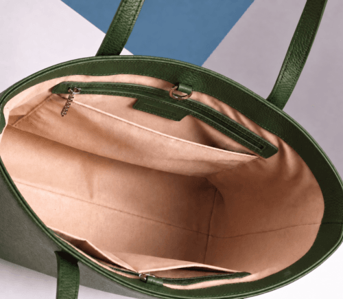 Inside view of green leather tote bag showing zip pocket and lining