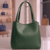Green leather tote bag displayed in a boutique setting