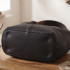 Black leather hobo shoulder bag with brown adjustable strap