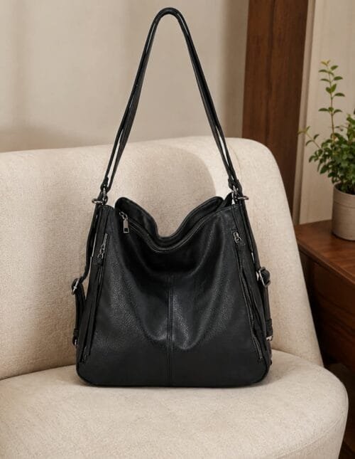 Handcrafted black leather convertible shoulder bag and backpack with multi-pocket design