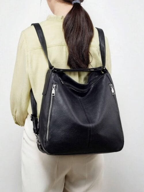 Handcrafted black leather convertible shoulder bag and backpack with multi-pocket design
