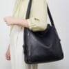 Handcrafted black leather convertible shoulder bag and backpack with multi-pocket design
