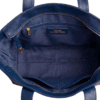 Open top view of navy blue leather bag showing spacious interior lining, zip compartment, and pockets Open top view of navy blue leather bag showing spacious interior lining, zip compartment, and pockets