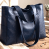 blue_hobo5 Navy blue handcrafted leather tote bag with sturdy shoulder straps and side pockets on a display stand.