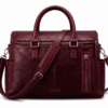 Front view of DayLifeLeather handcrafted maroon textured leather briefcase bag with shoulder strap on a white background.