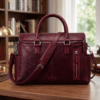 Front view of DayLifeLeather handcrafted maroon textured leather briefcase bag with shoulder strap on a white background.