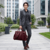 Model view of DayLifeLeather handcrafted maroon textured leather briefcase bag with shoulder strap on a white background.