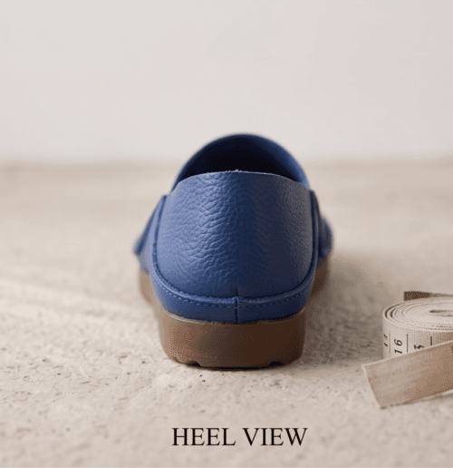 Men's navy blue pebbled leather slip-on shoes with beige ribbed sock-style collar and brown rubber sole