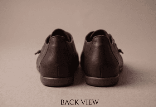 Dark brown leather and suede lace-up shoes for women, close-up texture view