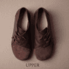 Dark brown leather and suede lace-up shoes for women, close-up texture view
