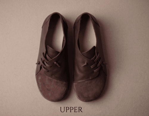 Dark brown leather and suede lace-up shoes for women, close-up texture view