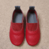 Maroon Genuine Leather Slip-On Loafers for Women Woman wearing maroon genuine leather slip-on loafers with cream trousers