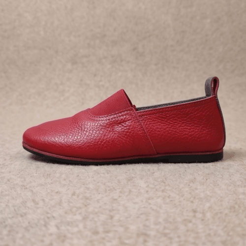 Maroon Genuine Leather Slip-On Loafers for Women Woman wearing maroon genuine leather slip-on loafers with cream trousers