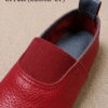 Maroon Genuine Leather Slip-On Loafers for Women Woman wearing maroon genuine leather slip-on loafers with cream trousers