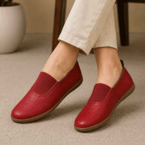Maroon Genuine Leather Slip-On Loafers for Women Woman wearing maroon genuine leather slip-on loafers with cream trousers