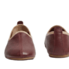 Men's maroon leather juti slip-on shoes with beige piping and suede-lined interior, side view