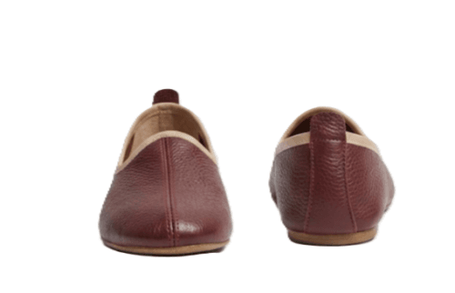 Men's maroon leather juti slip-on shoes with beige piping and suede-lined interior, side view
