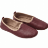 Men's maroon leather juti slip-on shoes with beige piping and suede-lined interior, side view