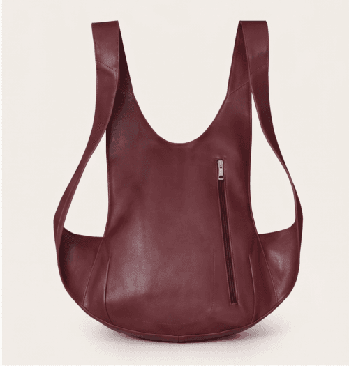 DayLife Leather handcrafted maroon ergonomic leather backpack worn by a female model on an urban street