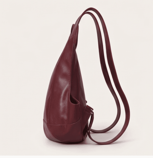 DayLife Leather handcrafted maroon ergonomic leather backpack worn by a female model on an urban street