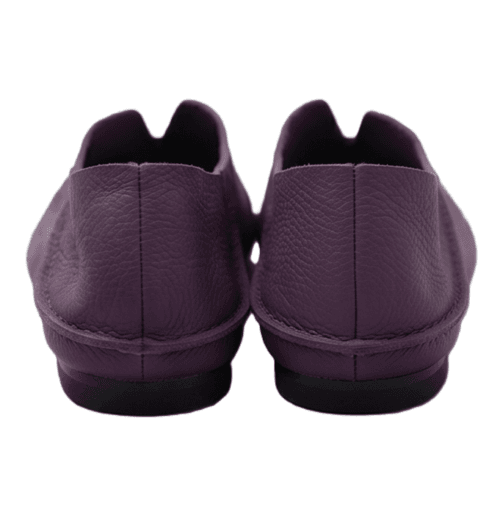 A product photography composite image showing a pair of handcrafted deep purple, pebbled leather flat shoes arranged in three views on a light gray background. The left panel shows the top-down (upper) view, the center panel shows the side profile, and the right panel shows the rear (back) view.
