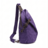 Male model wearing a vintage purple waxed canvas crossbody sling backpack by Daylife Leather on an urban cobblestone street, featuring product close-up and open interior view.