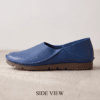 Men's navy blue pebbled leather slip-on shoes with beige ribbed sock-style collar and brown rubber sole