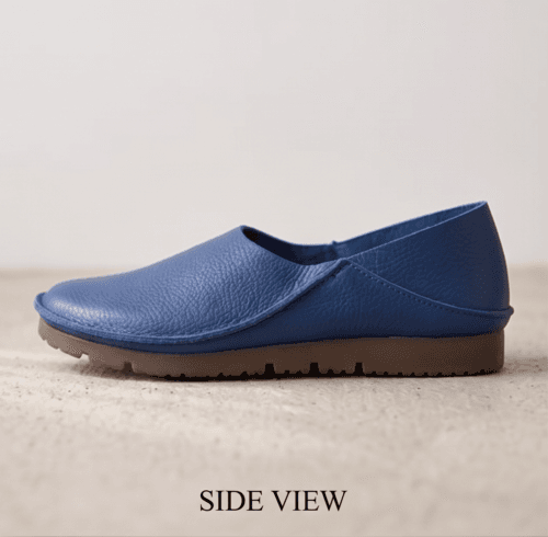 Men's navy blue pebbled leather slip-on shoes with beige ribbed sock-style collar and brown rubber sole