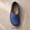 Men's navy blue pebbled leather slip-on shoes with beige ribbed sock-style collar and brown rubber sole