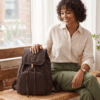 Daylife Leather dark brown canvas backpack showing front, side, padded back, and open upper interior compartment views.